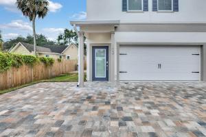 a house with a garage and a driveway at New 1/1 :Loft Minutes From Heart of Tampa -Unit C in Tampa