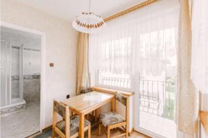 a dining room with a table and a window at Wędrowiec in Karwia +51 photos
