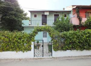 a house with a gate in front of it at Dimitris Studios Acharavi Corfu in Acharavi