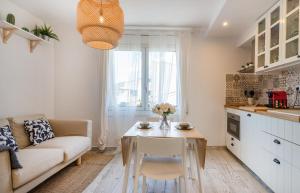 een woonkamer met een bank en een tafel bij Beautiful apartment stylish village house @ Center Cadaqués in Cadaqués