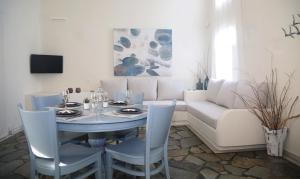 a dining room with a table and a couch at Dafni's Philoxenia in Naousa