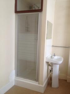 a bathroom with a shower and a sink at The Crystal Lodge Hotel in Croydon