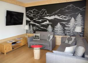a living room with a couch and a tv at Apartament w Jaworkach - Pod Wysoką in Szczawnica