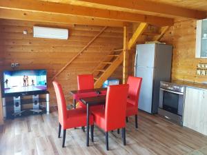 a dining room with a table and red chairs at Summer Holiday House MM in Ulcinj +16 photos