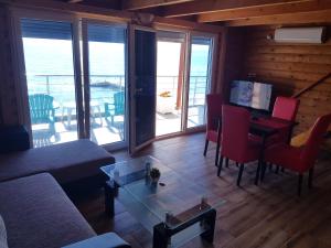 a living room with a couch and a table at Summer Holiday House MM in Ulcinj