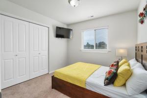 a bedroom with a bed and a flat screen tv at Terra House Tacoma in Tacoma