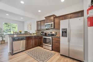 a kitchen with wooden cabinets and stainless steel appliances at Terra House Tacoma in Tacoma