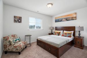 a bedroom with a bed and a chair at Terra House Tacoma in Tacoma