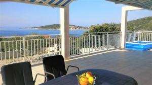 a balcony with a table and a view of the ocean at Vila Rosa in Sevid