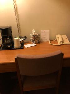 a desk with a coffee maker and a phone on it at Coronado Motel & RV Park in Lindsborg