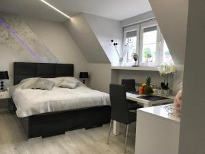 a bedroom with a bed and a desk and a tableablish at Novel Old Town in Warsaw
