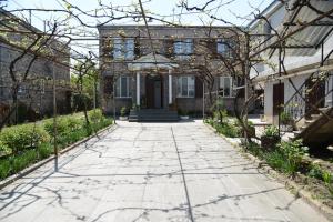 a house with a walkway leading to the front door at Olimpo Guest House in Akhaltsikhe