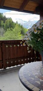 a wooden fence with a potted plant on a patio at Apartment Alpska Astra in Kranjska Gora
