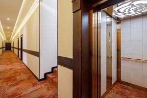 a corridor of a hotel with a hallway of elevators at Dacha Resort Hotel in Gelendzhik