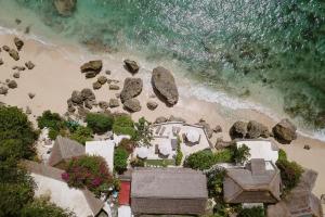 an aerial view of a beach with rocks and the ocean at Rock'n Reef in Uluwatu