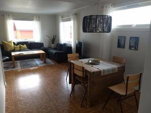a living room with a table and a couch at 43 Oscarsgate in Vadsø