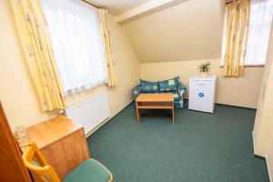 a small room with a chair and a table at Pension KA.PR in Hluboká nad Vltavou