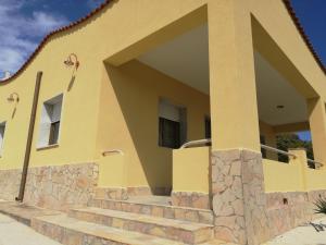a yellow house with stairs in front of it at Villa Fiorella in Sciacca