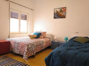 a bedroom with two beds and a teddy bear sitting on a bed at Junto a la Plaza Mayor II in Salamanca