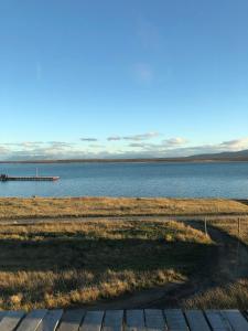 a view from a bench overlooking a body of water at Hotel Simple Patagonia in Puerto Natales