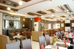 a dining room with tables and chairs in a restaurant at Hotel Orbit in Chandīgarh