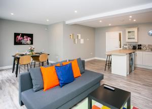 a living room with a blue couch and a kitchen at University Road Apartments in Belfast