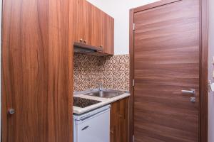 a small kitchen with a sink and a wooden door at Pension Maria in Astris