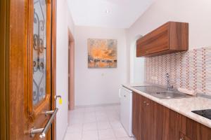 a kitchen with a sink and a counter top at Pension Maria in Astris +68 photos