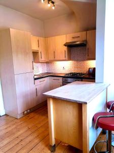 a kitchen with wooden cabinets and a counter top at The Herring Queen in Eyemouth