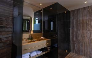 a bathroom with two sinks and a large mirror at Vila Foz Hotel & SPA - member of Design Hotels in Porto