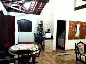 uma cozinha com uma mesa e um balcão num quarto em Recanto Shambala em São Tomé das Letras