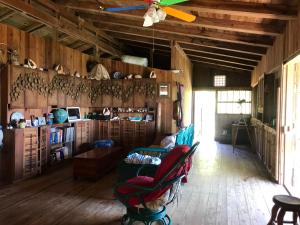 a living room with a couch and a ceiling fan at Guanaja Backpackers Hostel in Guanaja