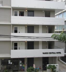 a large white building with a large window at Waikiki Central Hotel - No Resort Fees in Honolulu