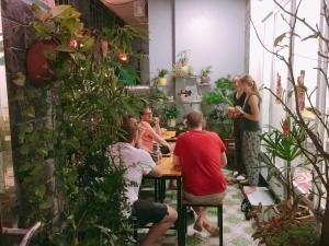 a group of people sitting at a table in a restaurant at Cat Ba Central Homestay in Cat Ba