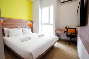 Krevet ili kreveti u jedinici u okviru objekta LeGreen Suite Kuningan