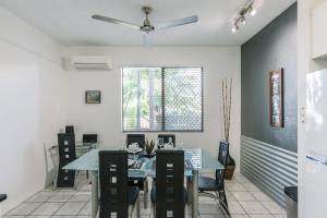 a dining room with a table and chairs at CitySide Apartment - 2 Bedroom with Private Courtyard in Darwin
