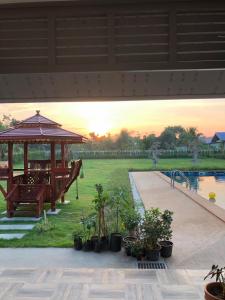 a patio with a gazebo and a pool at Pakham Gardens Resort in Prakham