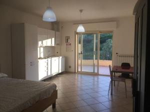 ein Schlafzimmer mit einem Bett und einem Tisch sowie eine Küche in der Unterkunft La Perla in Silvi Marina