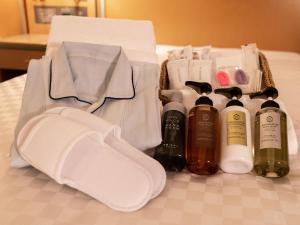 a group of bottles of alcohol sitting on a bed at Keio Plaza Hotel Hachioji in Hachioji