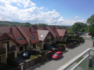 a row of houses with cars parked in a parking lot at Salt Mine Apartment 64m2 in Wieliczka