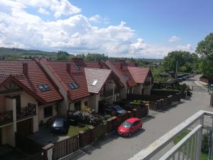 a row of houses with cars parked in a parking lot at Salt Mine Apartment 64m2 in Wieliczka