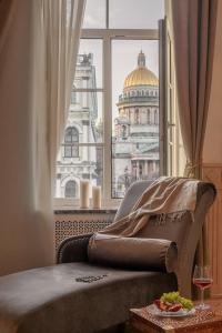 a room with a bed and a window with a building at Agent Flat Apartment in Saint Petersburg