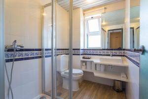 a bathroom with a toilet and a sink and a mirror at Hotel Alcatruz in Aljezur +33 photos