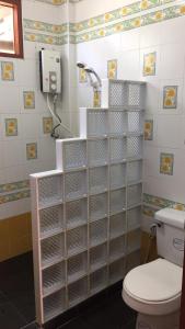 La salle de bains est pourvue de toilettes et d'une douche avec des cloisons. dans l'établissement Poon Suk Hotel Kabin Buri, à Kabin Buri