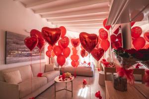 a room with a bunch of red heart balloons at Il Sogno di Manarola by The First in Manarola
