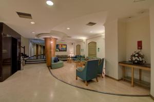 a lobby with chairs and a couch and a table at Tristar Serviced Apartments in Bengaluru