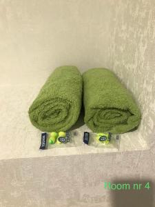 two green towels and some balls on a counter at Liivalaia 40 cozy kitchen studio in Tallinn