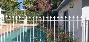 a white fence next to a swimming pool at Beatrice in Perth