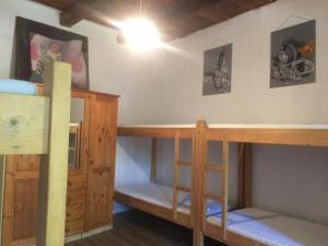 a room with two bunk beds and a desk at Almásliget Vendégház in Mátramindszent