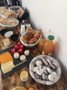 a table topped with plates of pastries and other foods at Au pied de la dune in Sangatte